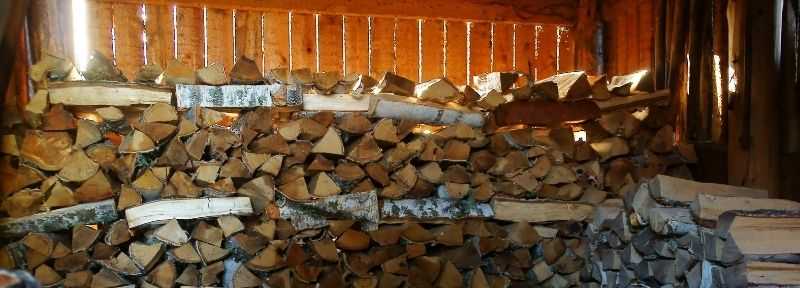 Logs seasoning in a barn rather than kiln drying