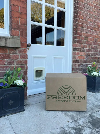 XL Box of Easy Light Freedom Kindling by a doorstep, ideal for firewood.