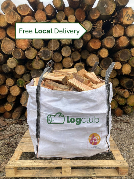 Bag of firewood with 'Log Club' branding in front of stacked logs, featuring 'Free Local Delivery' text.